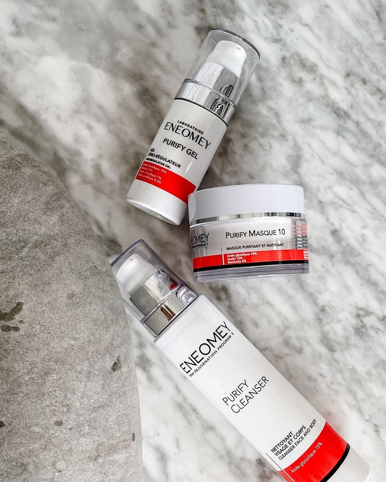 Three skincare products from Enemey on a textured surface