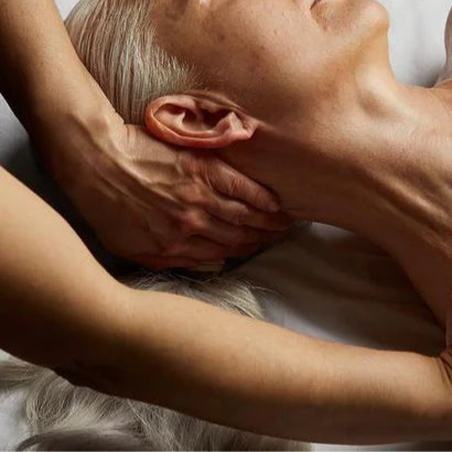 Person receiving a massage on a wooden floor