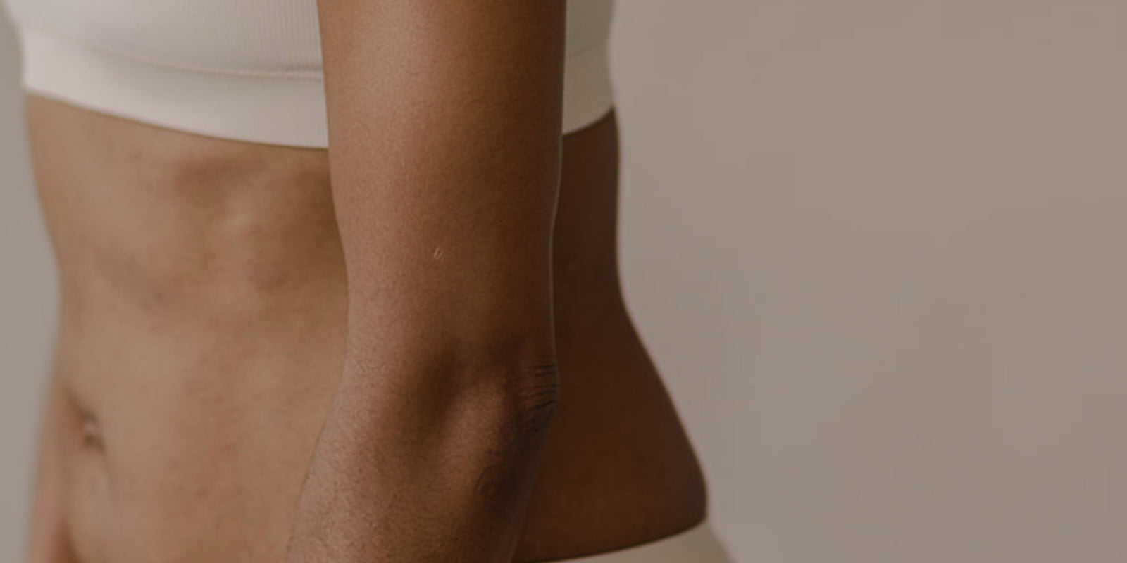 Close-up of a person's legs with a neutral background