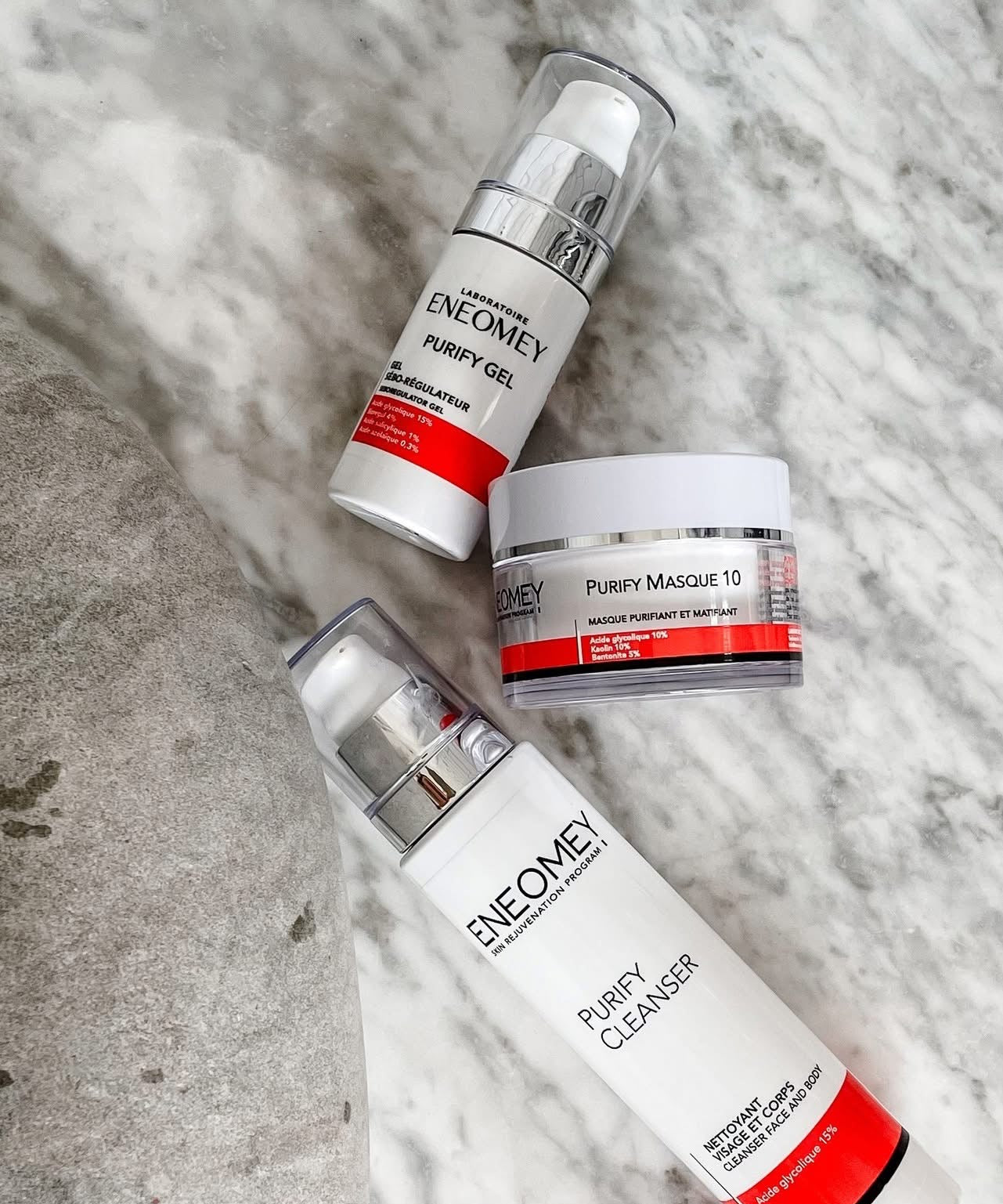 Three skincare products from Enemey on a textured surface