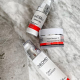 Three skincare products from Enemey on a textured surface
