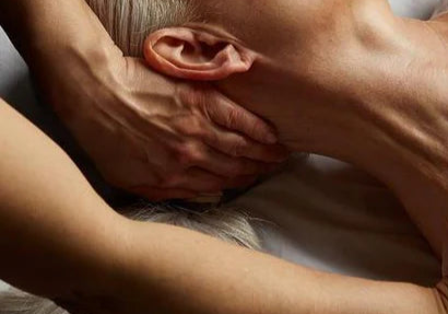 Person receiving a massage on a wooden floor